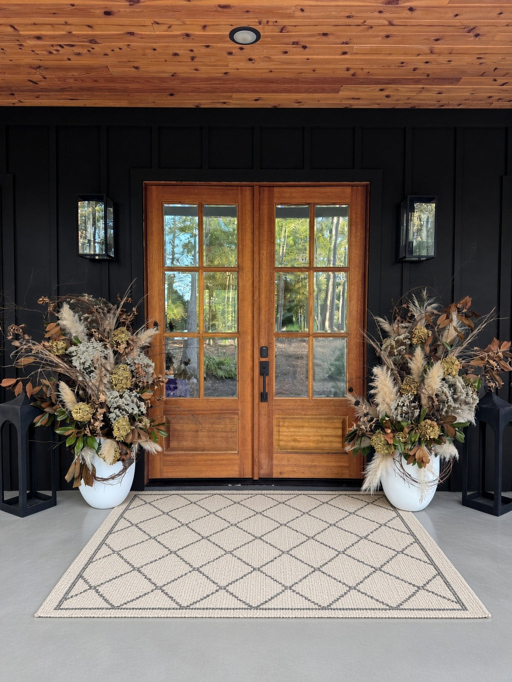 Beautiful Planters: a pair of dried pampas, hydrangea, and magnolia planters at wood double doors