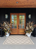 Beautiful Planters: a pair of dried pampas, hydrangea, and magnolia planters at wood double doors