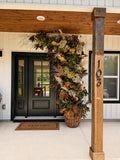 Welcome Home Arch - HALF rising from a woven basket beside a black front door